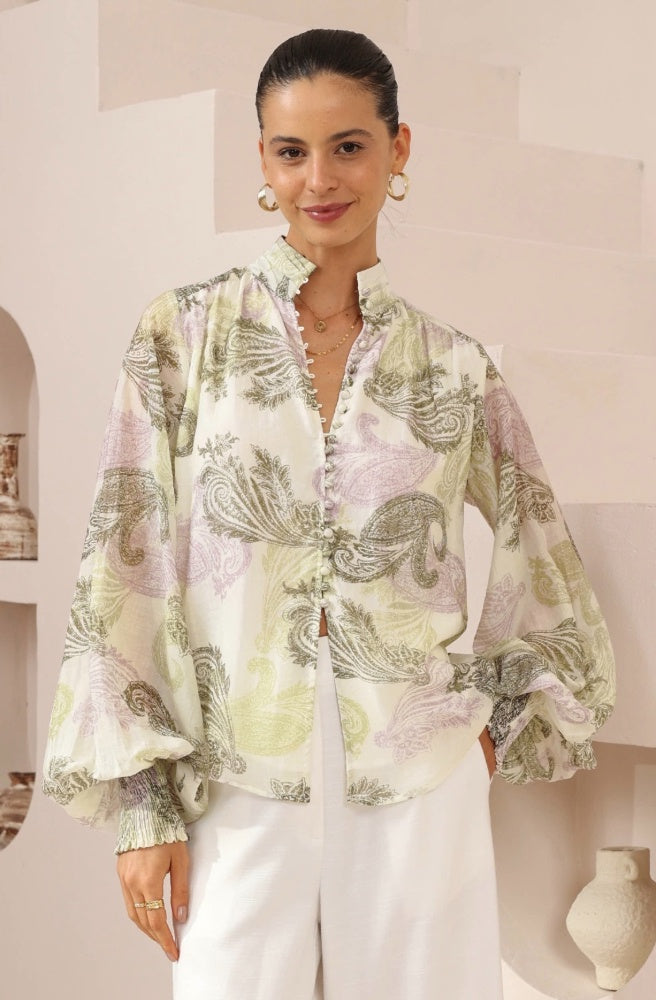 Paisley Dreaming Blouse, Woman wearing a paisley blouse in an indoor setting