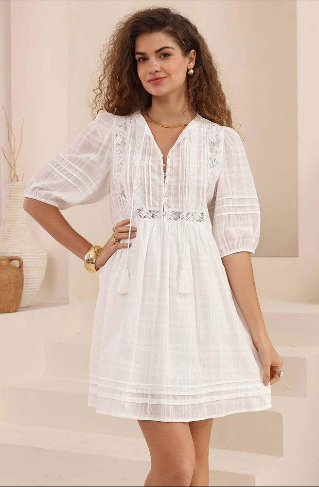 Woman wearing a white dress in a neutral setting