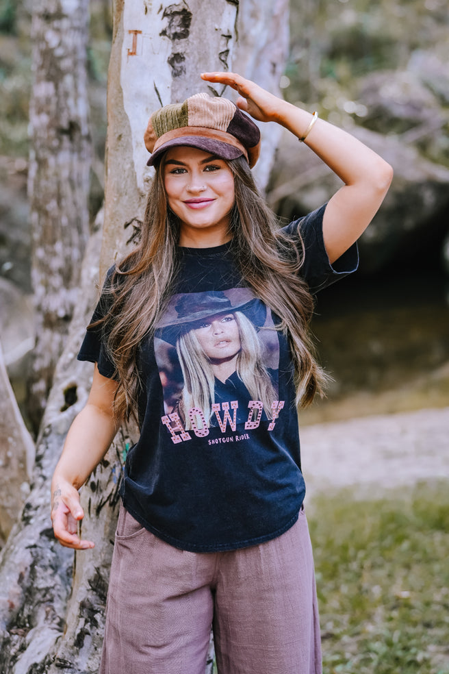 Woman wearing a graphic t-shirt with a nature background
