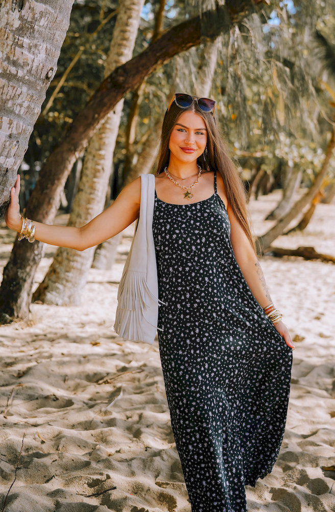 Bitsa Dune Dress in a black ditsy floral print with adjustable straps and flowing maxi silhouette