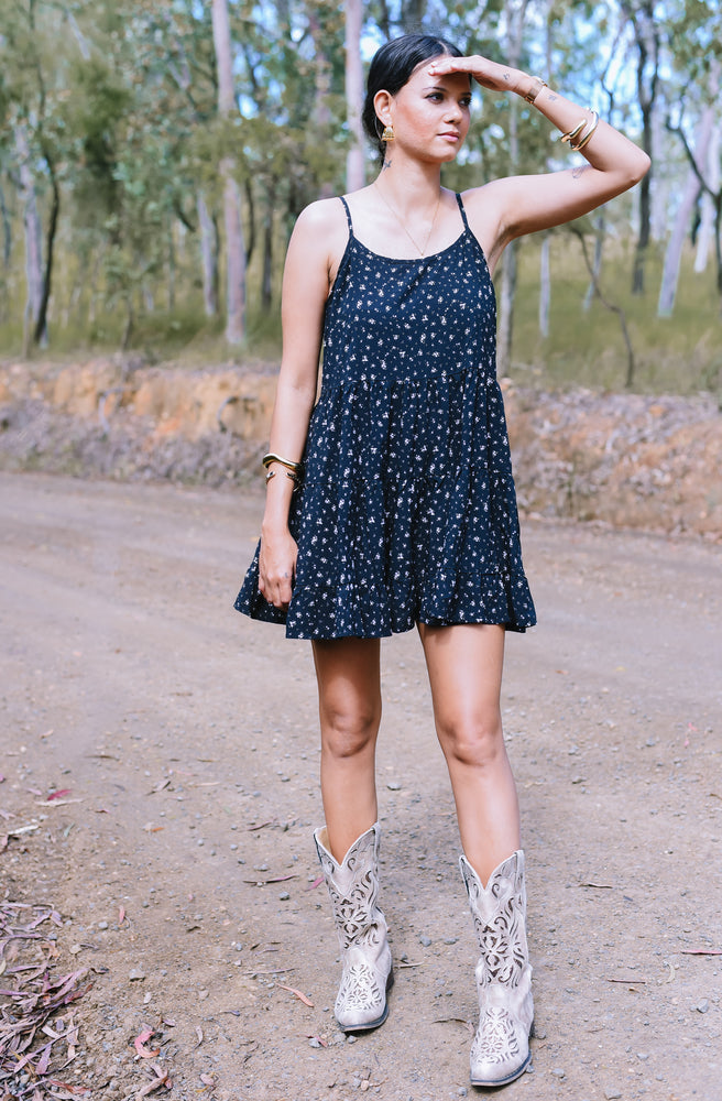 Bitsa Mixie Mini Dress in black floral print with adjustable straps and open tie-back