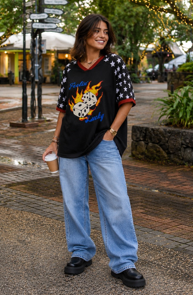 Black Lucky Charm Tee with flaming dice graphic and star-print sleeves