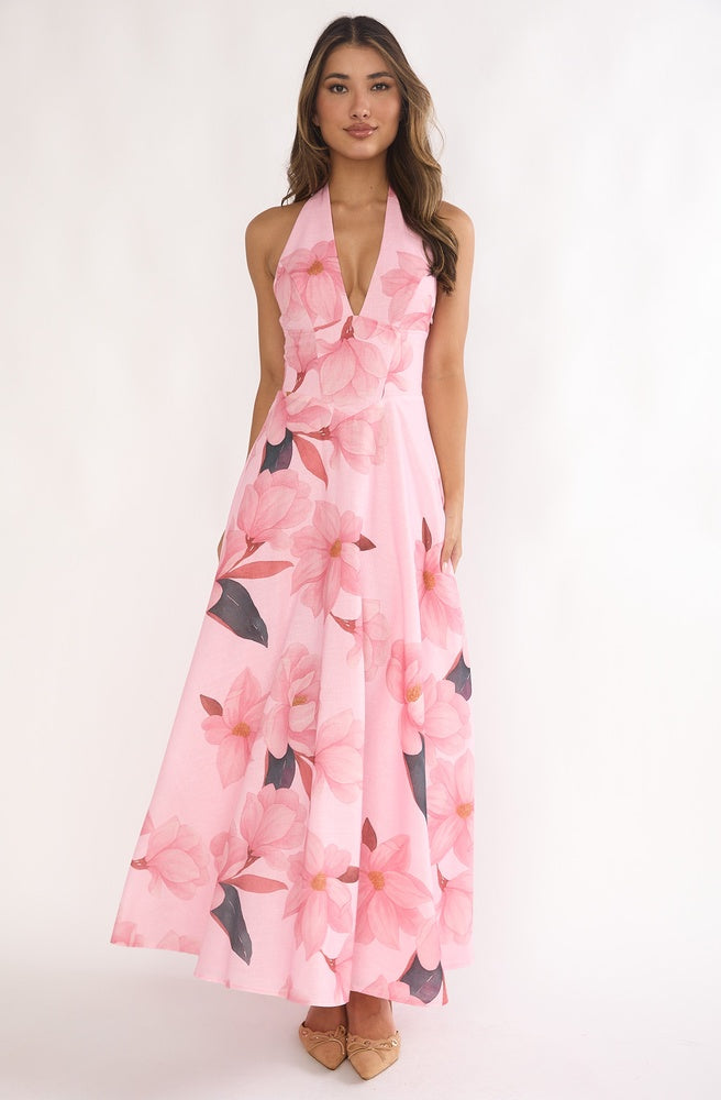Model wearing Tonketti Blush Floral halter maxi dress with soft pink floral print and flowing A-line skirt.