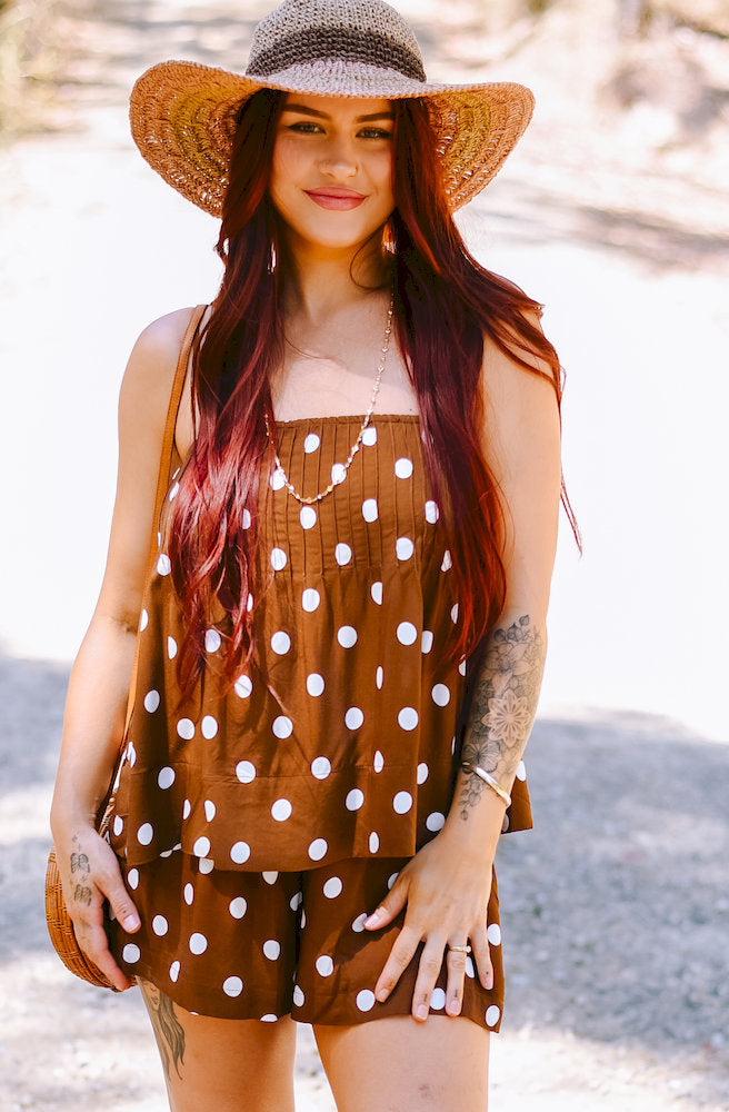 Brown Polka Dot Playsuit with white polka dots, adjustable straps and a relaxed fit.