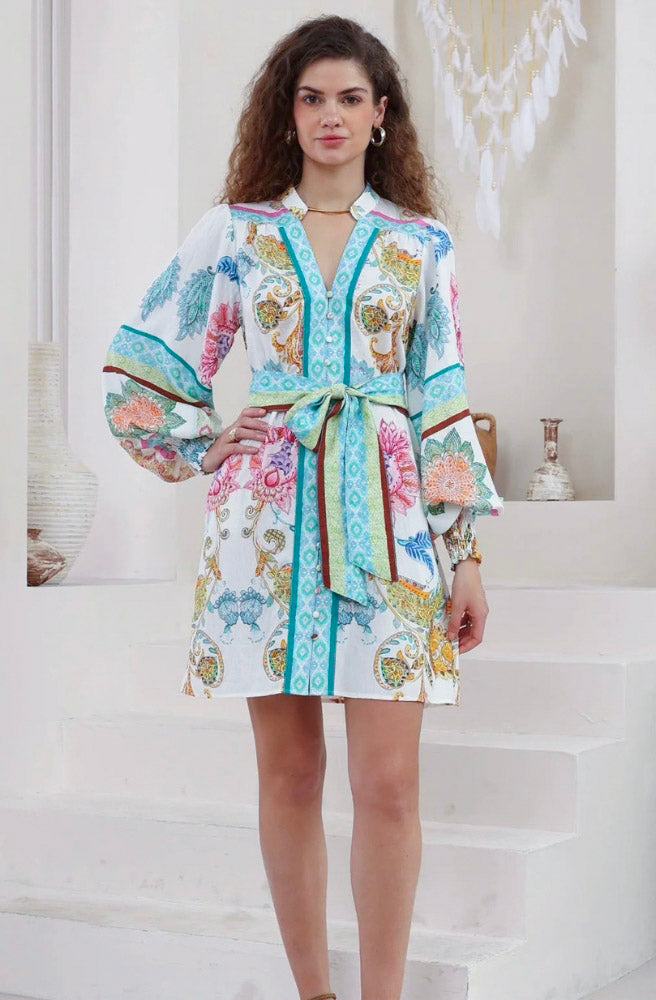 Women's Calipso Bloom long sleeve mini dress with floral paisley print, waist tie, and shirred cuffs