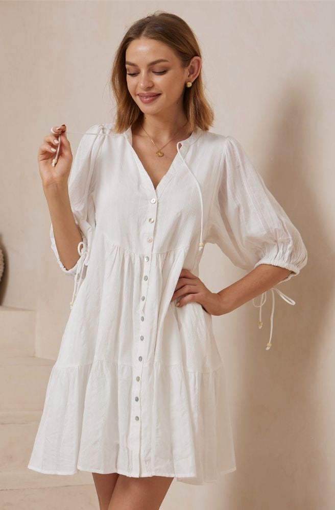 Celestial Muse Babydoll Mini with tiered skirt, button front, and drawstring sleeves.