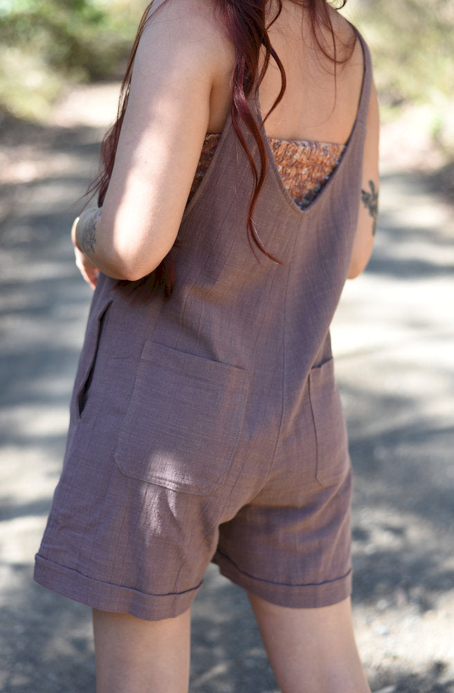 Back view of the Choc Gift Manifest Overalls showing the relaxed short-leg silhouette and functional back pockets.