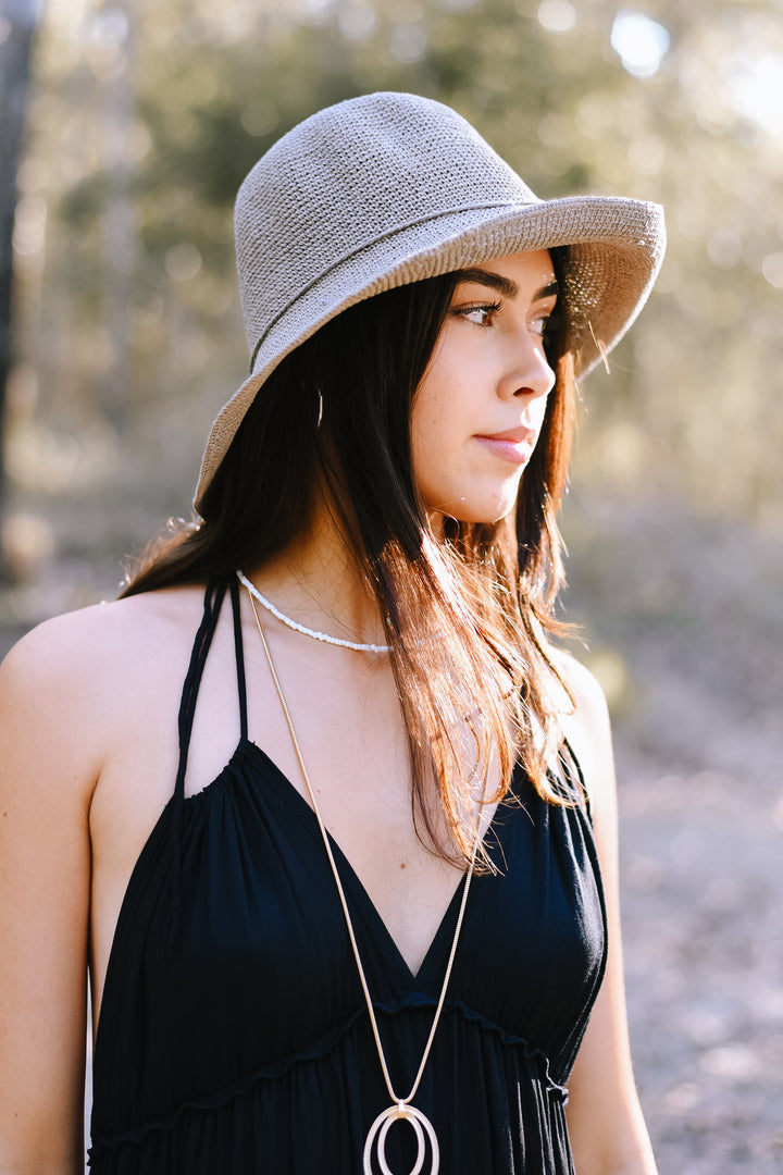 Classic Almond Bucket Hat with a textured woven finish and gently curved brim.