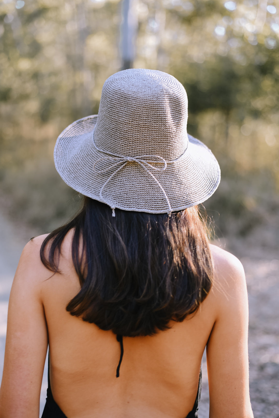 Back view of the Classic Almond Bucket Hat featuring a decorative matching tie.