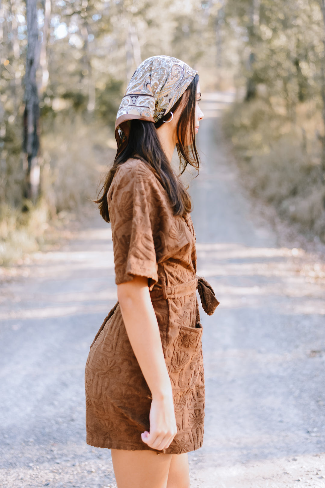 Side view of the Cocoa Cloud Towelling Robe showing its textured fabric, wrap design and short-sleeved silhouette.