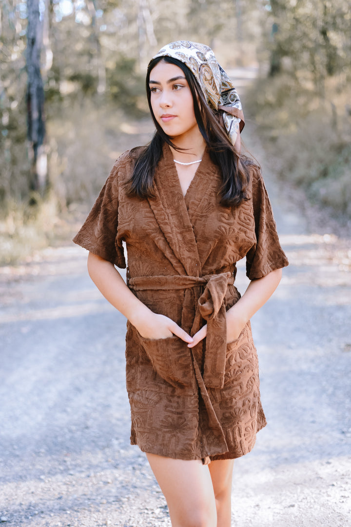 Front view of the Cocoa Cloud Towelling Robe in cocoa brown with embossed texture, short sleeves, front pockets and a matching waist tie.