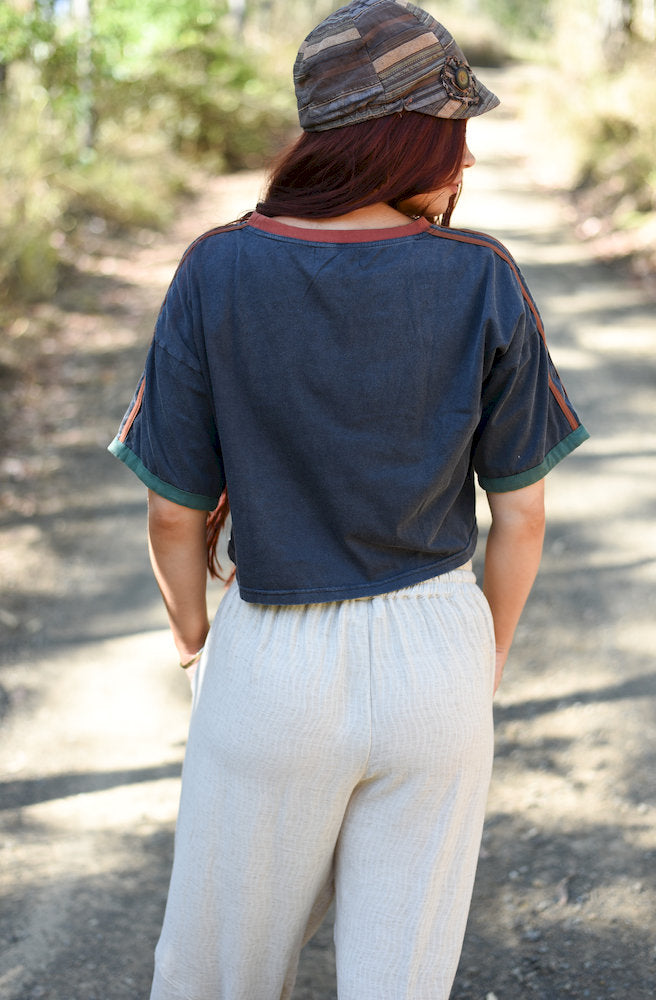 Back view of the Dirty Hippy Crop Top showing its relaxed cropped silhouette and contrasting sleeve and shoulder details.