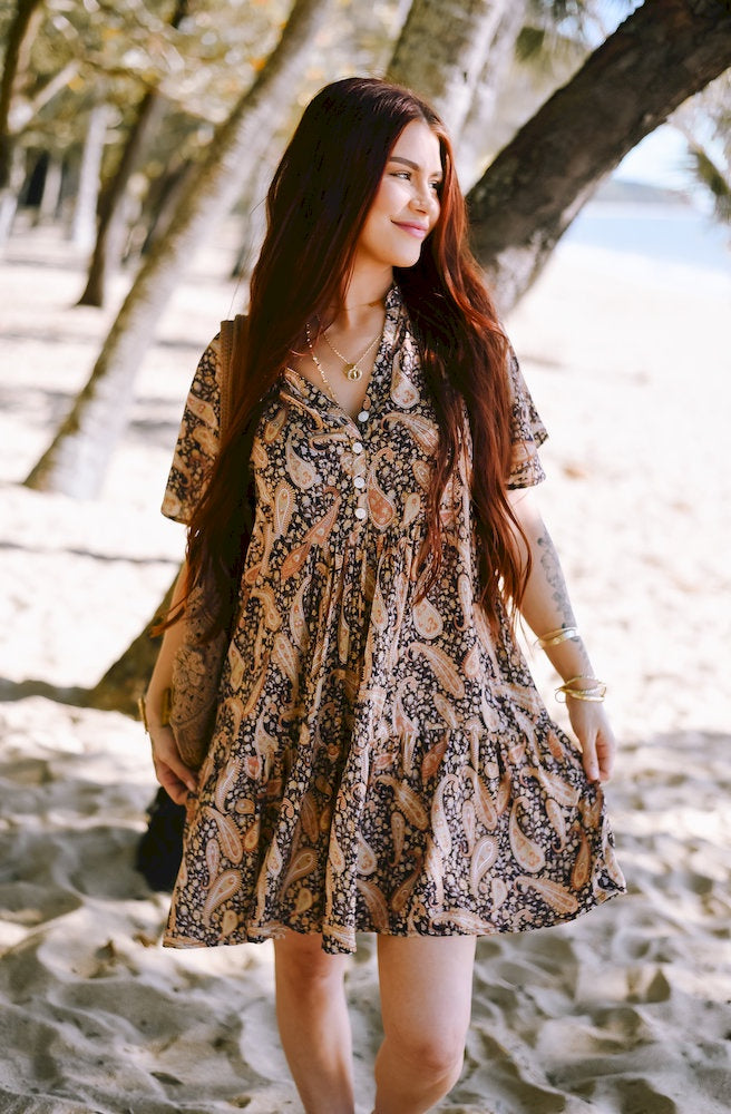 Dusk Paisley Cherry Mini Dress featuring a rich navy, beige, blush and cream paisley print, relaxed tiered mini silhouette and V-neckline.