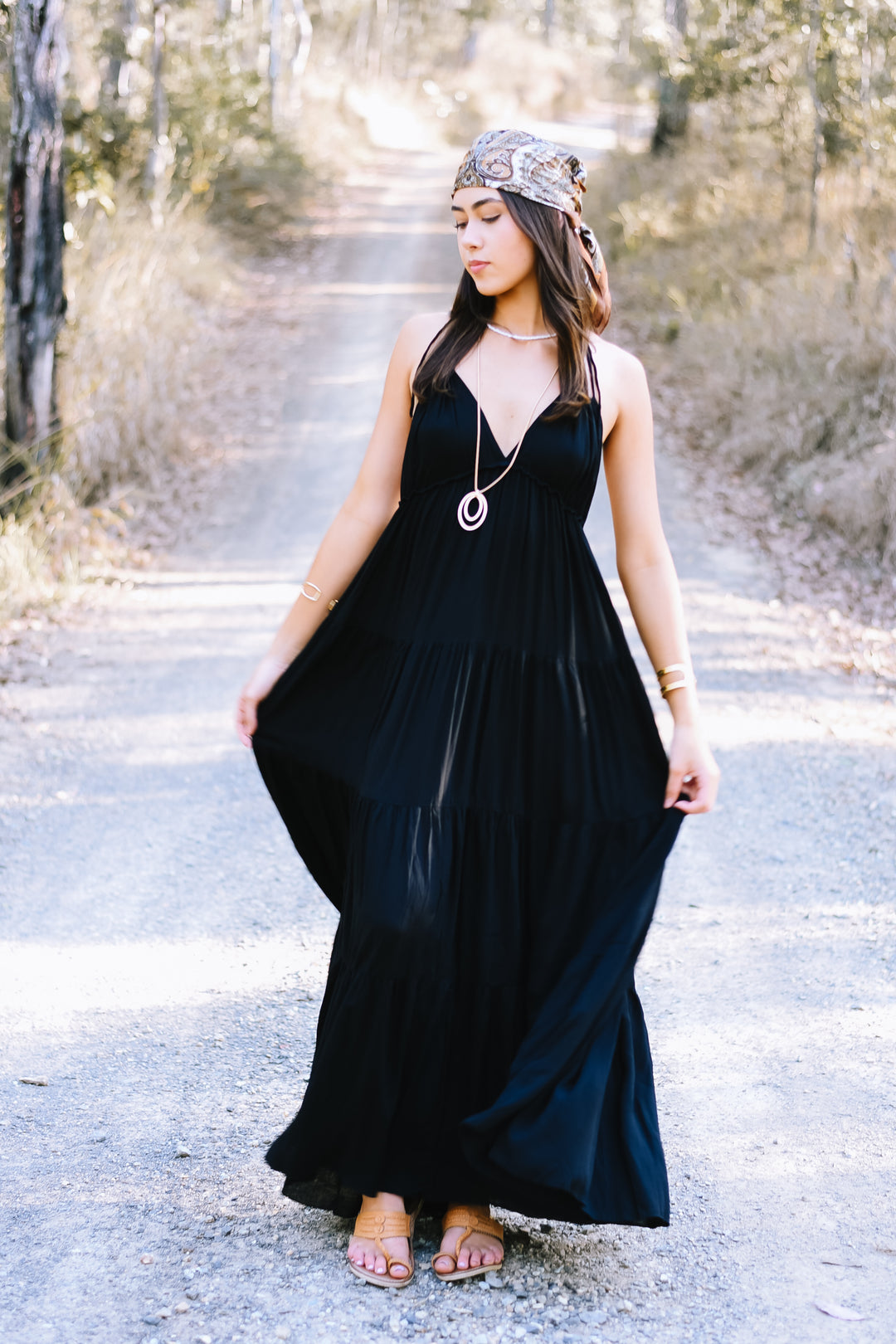 Ebony Umbrella Dress showcasing its open-back design and elegant, floor-length silhouette.