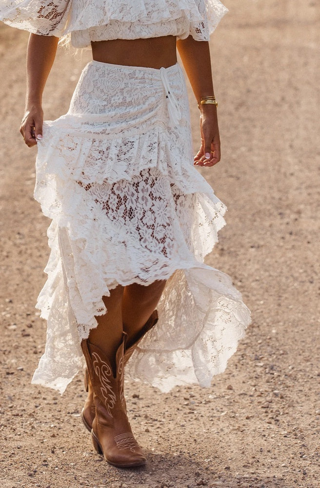 Women's white lace skirt with layered frills, elasticated waist and adjustable length.
