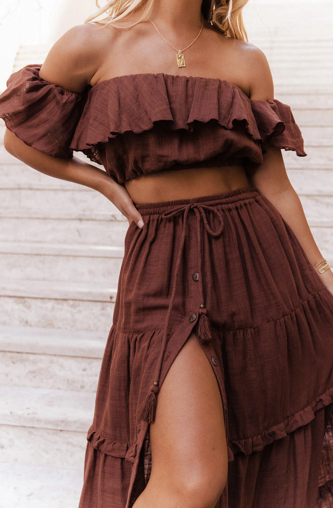 Close-up of the Esmeralda Chocolate Maxi Skirt showing its front buttons, adjustable tassel drawstring and soft cotton texture.