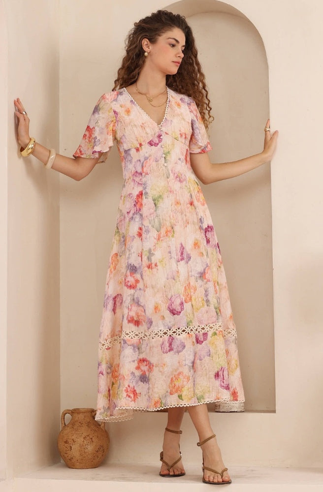 Flora Belle Maxi Dress in soft pastel floral print with V-neckline, short sleeves and flowing maxi skirt