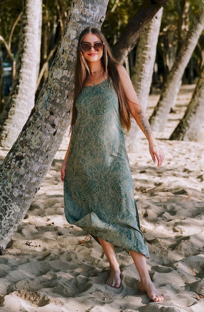 Forest Essence Dune Dress in a soft green botanical print with adjustable straps and flowing rayon maxi silhouette
