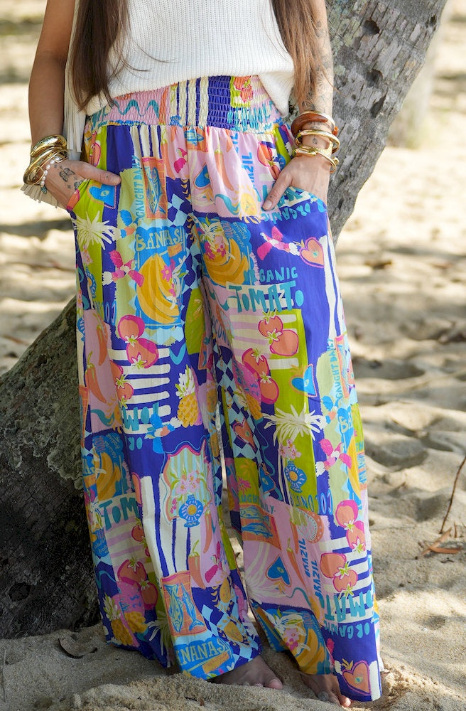 Funky Pineapple Queen Pants featuring a colourful tropical print with relaxed wide-leg fit and shirred waistband