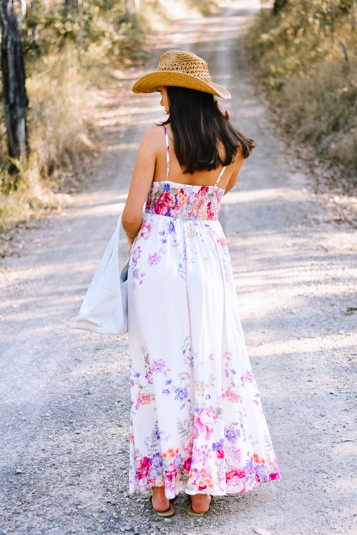 Back view of the Garden Bloom Maxi Dress showing the shirred bodice, adjustable shoulder straps and flowing floral skirt.