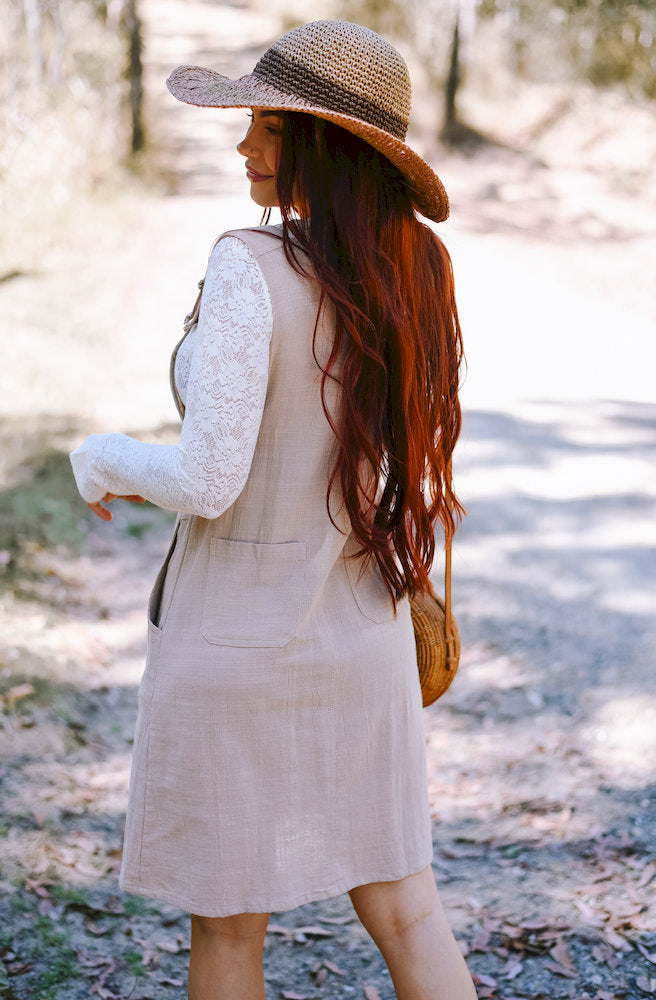 Back view of the Gypsy Thread Pinafore Mid Short Cream showing its simple back design and functional patch pockets.