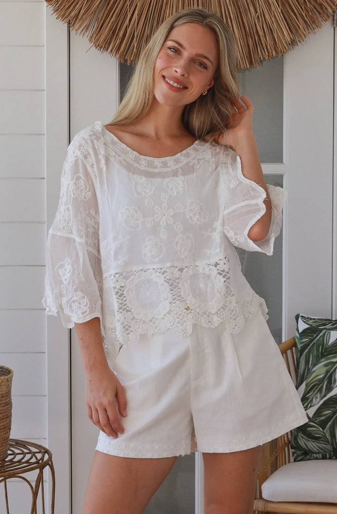 Ivory Daydream Lace Top styled with white shorts in coastal boho setting