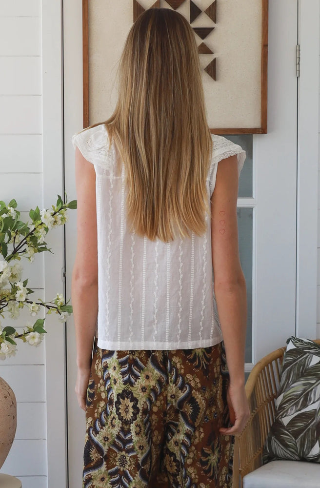 Back view of the Ivory Lace Ruffle Top showing its relaxed silhouette and textured lace detailing.