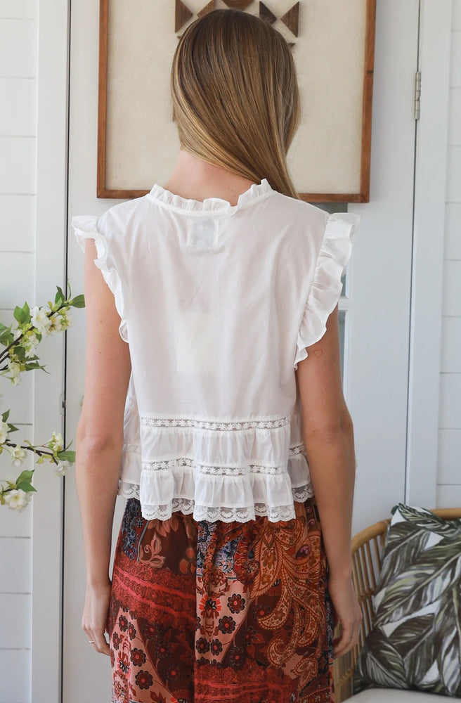 Back view of the Ivory Pleated Peplum Top showing flutter sleeves and layered lace detailing.