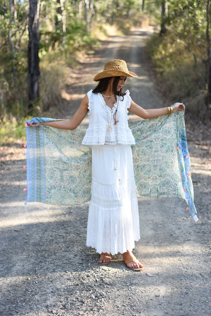 Mint Meadow Scarf featuring delicate mint, sage, blue and blush floral prints with decorative tassel ends.