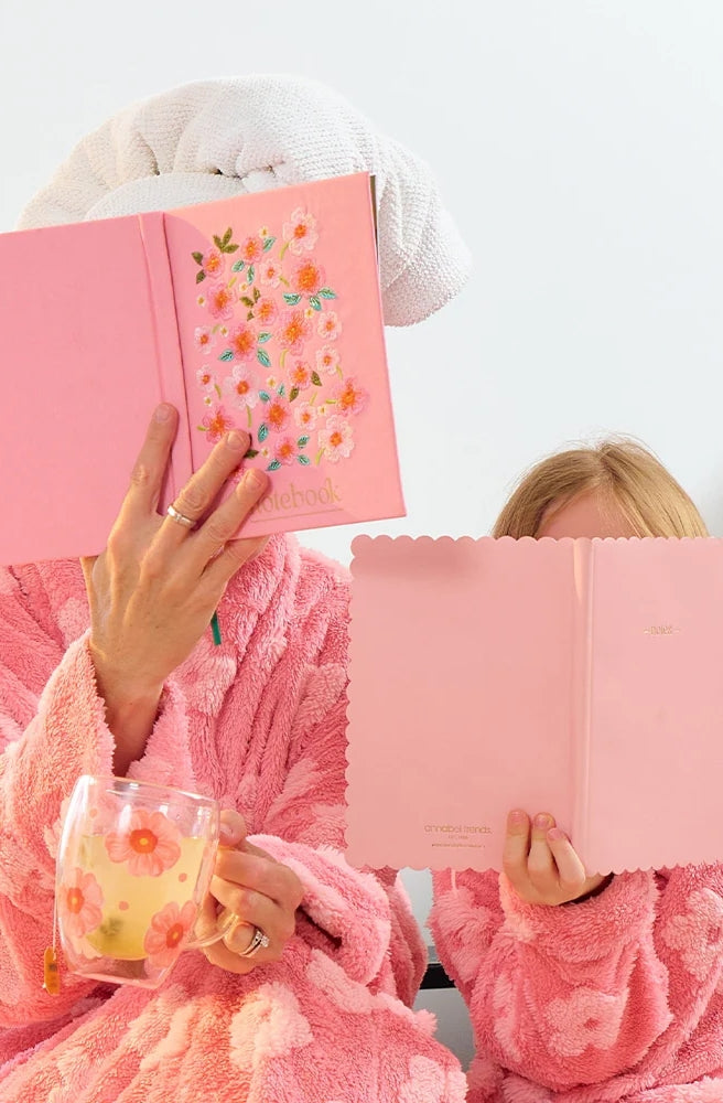 Close-up of the Journal – Notebook Meadow Blush with floral embroidery and gold notebook lettering.