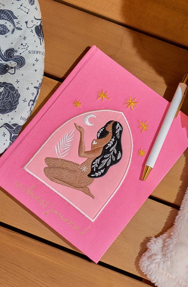 Journal – Wellness Woman featuring an embroidered woman design on the cover.