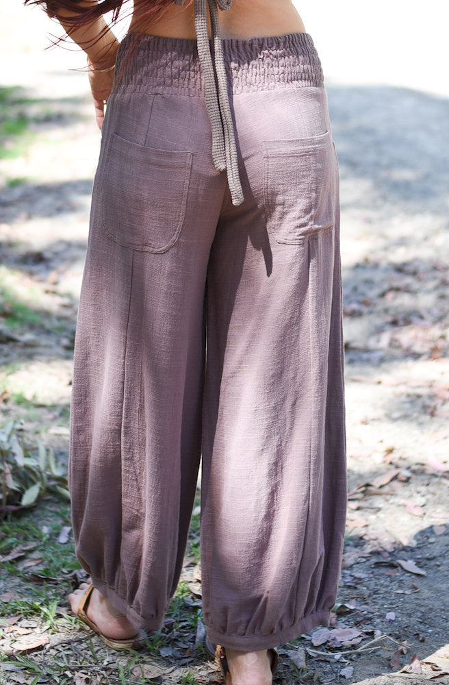Back view of the Gypsy Thread Pinafore Mid Short Cream showing its simple back design and functional patch pockets.