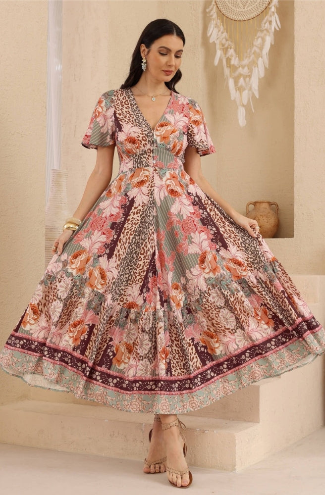 Leopard Caravan Maxi Dress featuring a colourful leopard, paisley and floral patchwork print, V-neckline and flowing maxi skirt.

