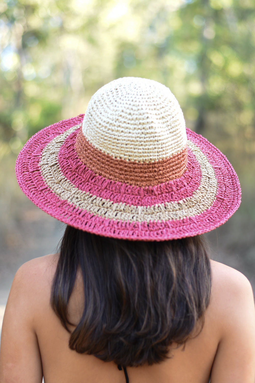 Blush pink and cream Medium Blush Brim Sun Hat with a rounded woven crown and contrasting beige band, styled with a black summer dress