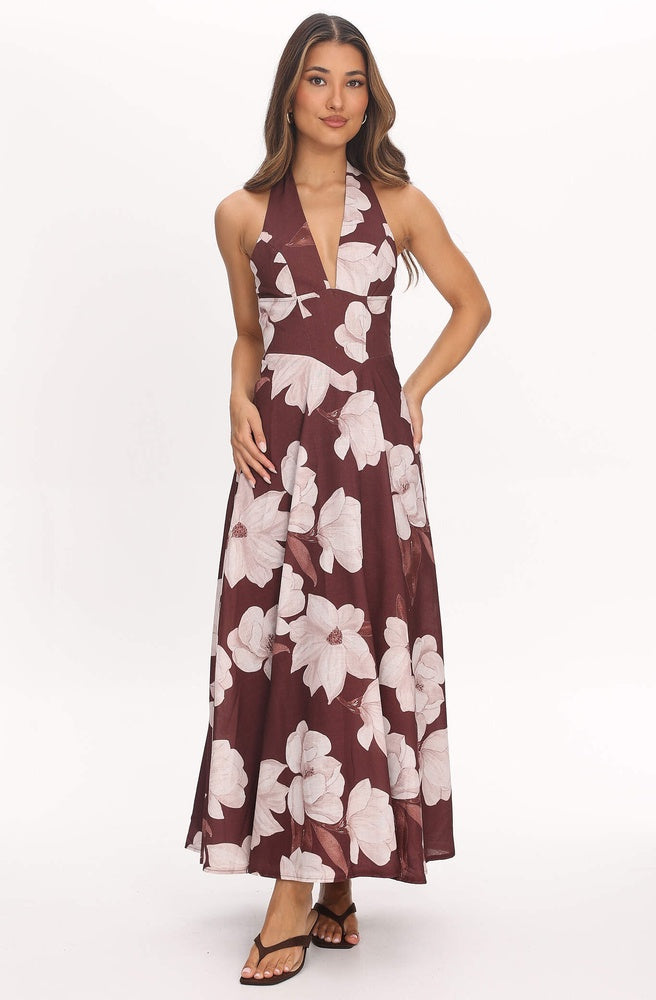 Model wearing Tonketti Mocha Magnolia halter maxi dress with brown base and soft magnolia floral print.