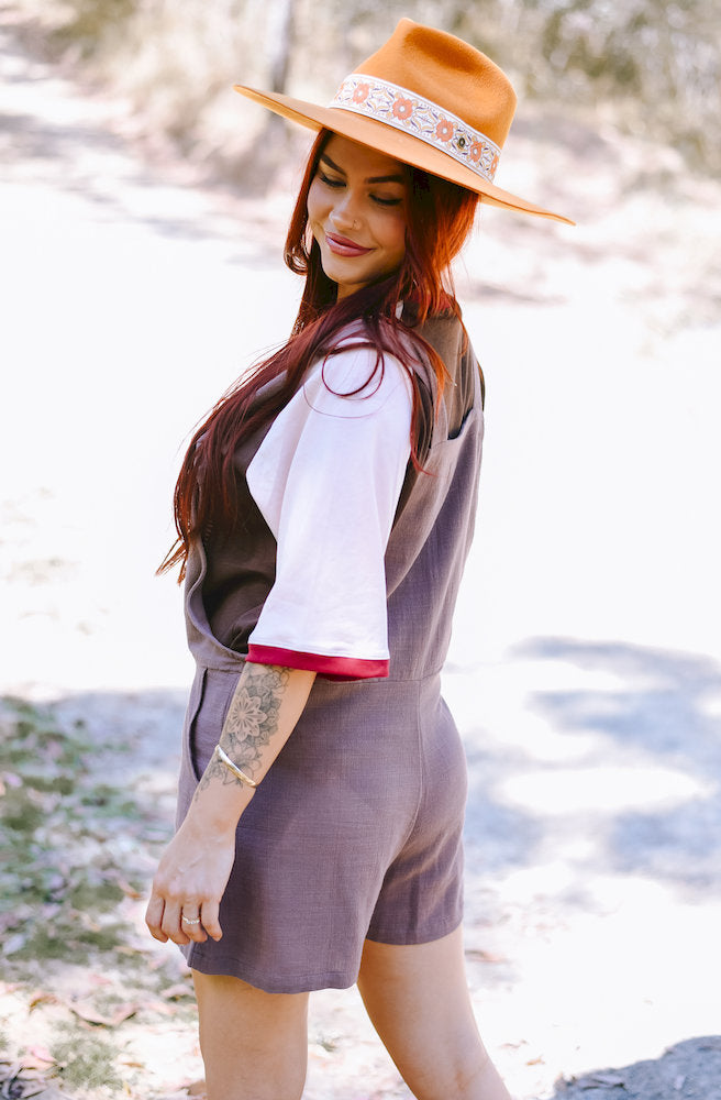 Back view of the Mocha Short Tide Overalls showing the relaxed short-leg silhouette and functional back pockets.