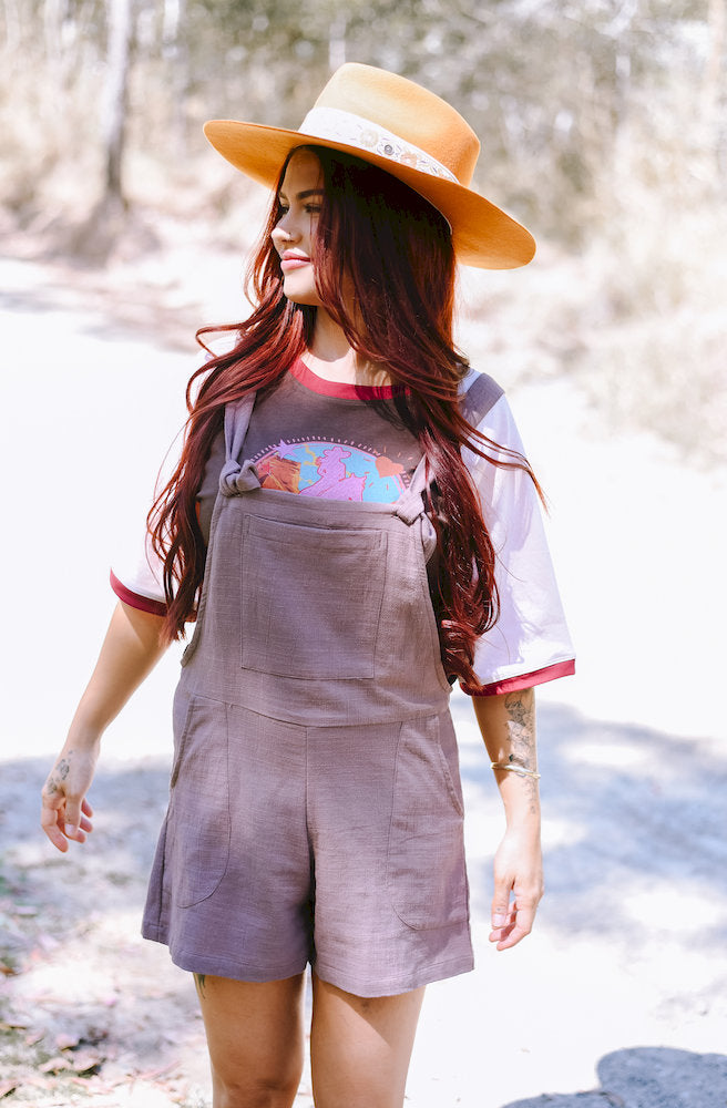 Mocha Short Tide Overalls featuring a muted mocha shade, adjustable shoulder straps and a celestial-embroidered front pocket.