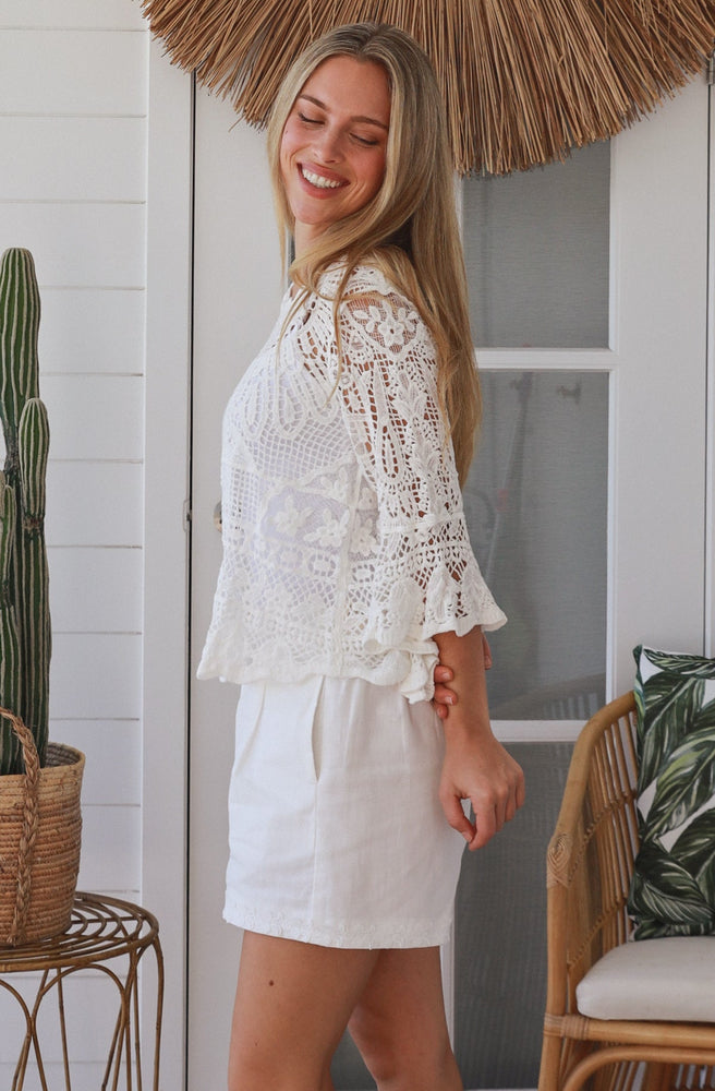 White boho crochet cotton top with relaxed sleeves and scalloped hem