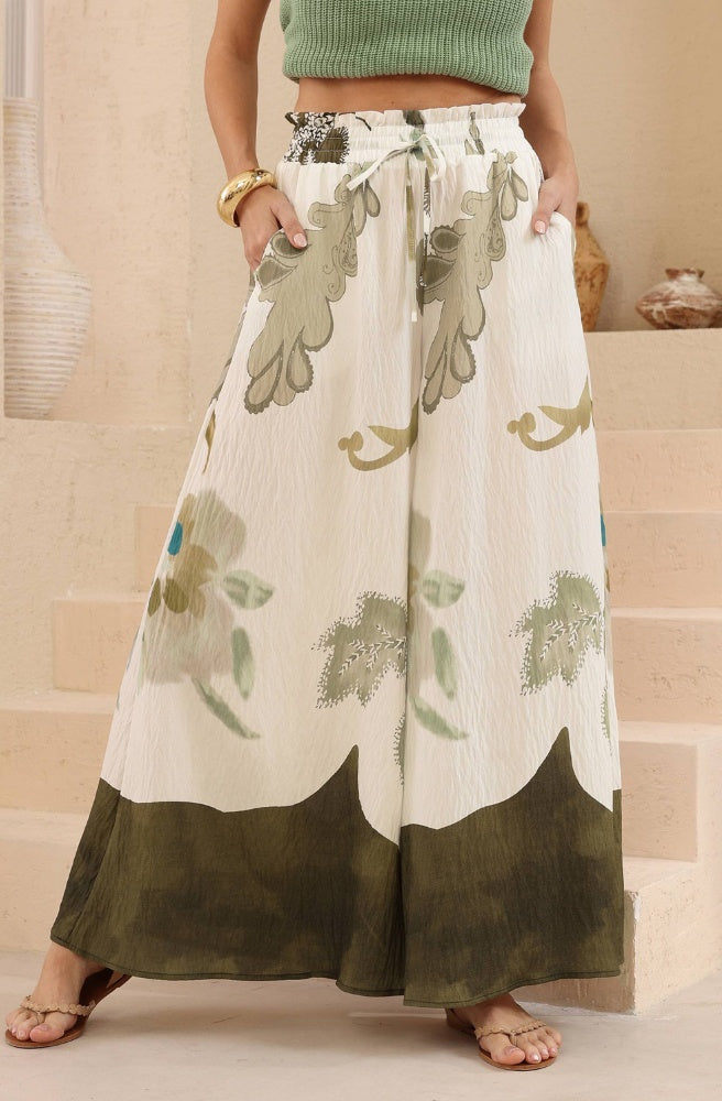 Olive Bloom Wide-Leg Pants in an earthy floral print with a flowing silhouette and elasticated drawstring waist.