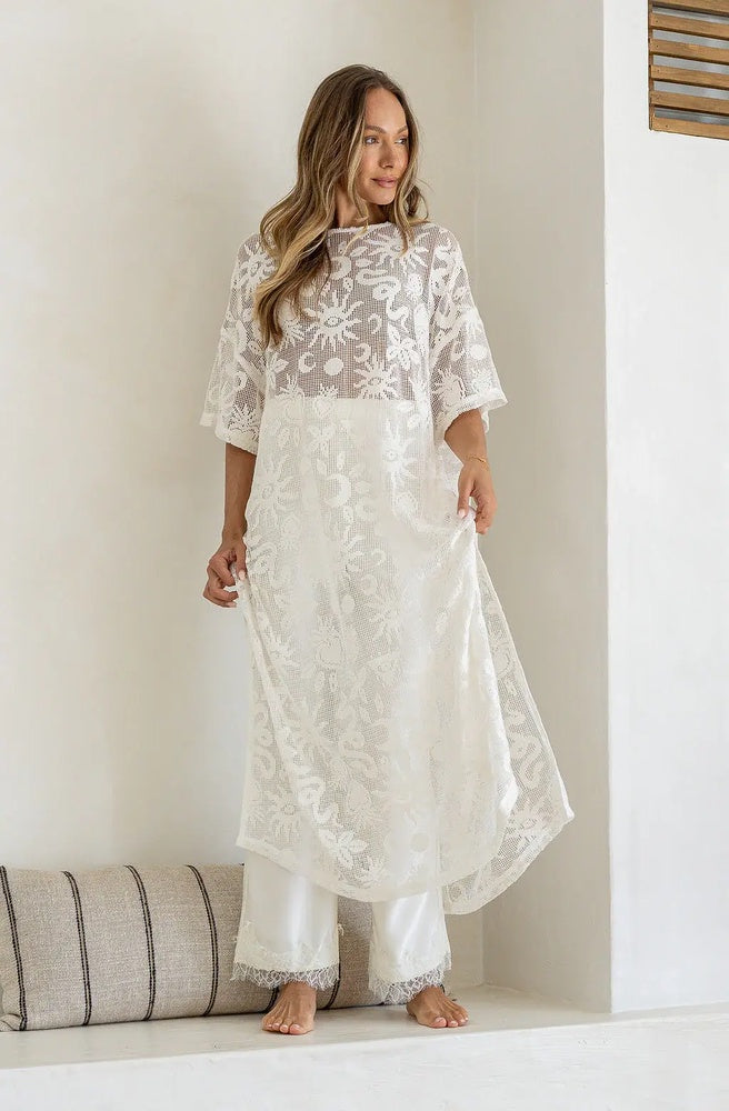 White floral lace maxi shift dress with relaxed sleeves and flowing silhouette for resort and occasion wear.
