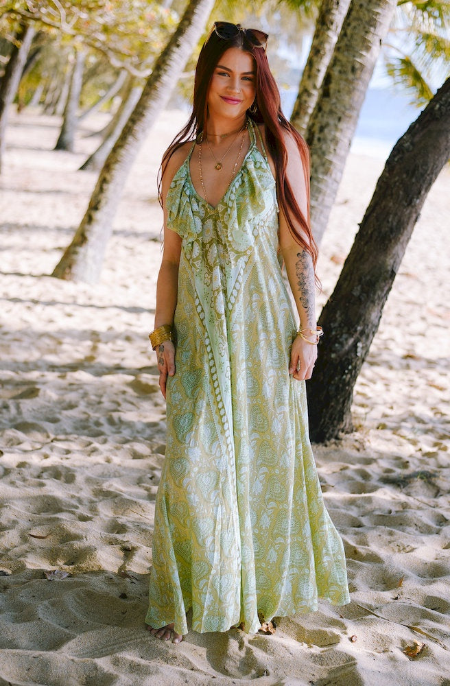 Paisley Mint Kiss Halter Dress featuring a soft mint and white paisley print, flowing maxi silhouette and flattering halter neckline.