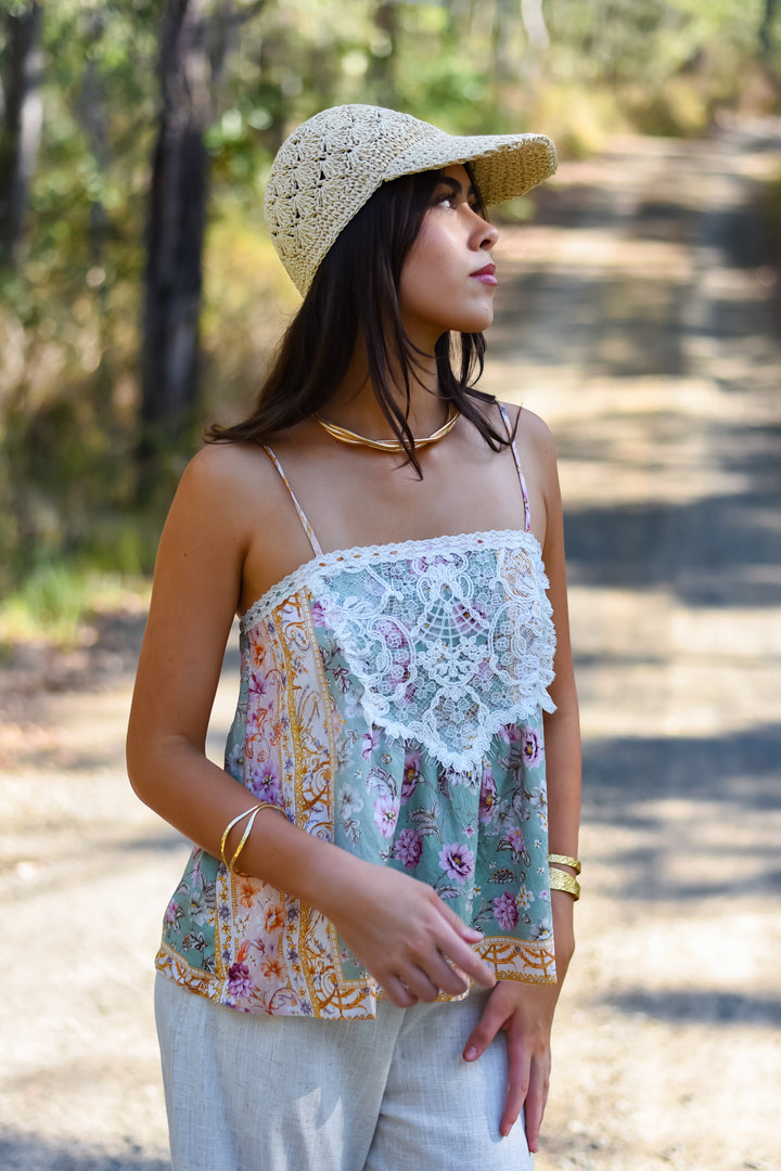 Front view of the Pastel Mosaic Lace Singlet featuring a sage-green floral print, white lace front panel and adjustable shoulder straps.