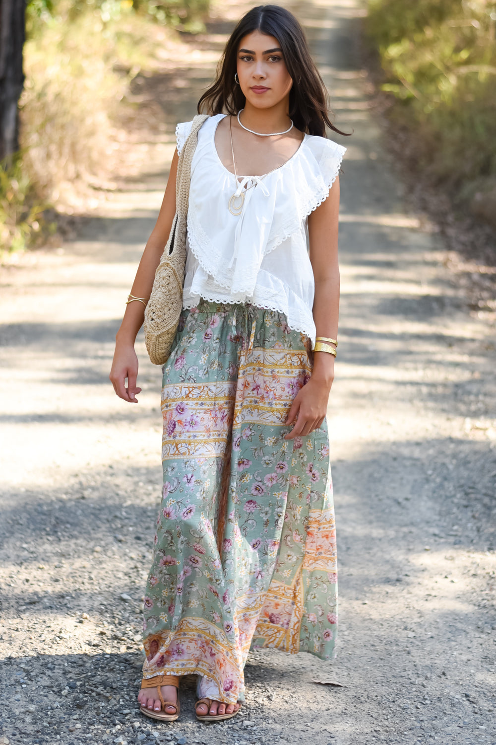 Front view of the Pastel Mosaic Maxi Pants featuring a sage-green floral print, pastel decorative borders and a relaxed wide-leg silhouette.