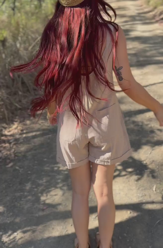 Model spinning in the Cream Manifest Overalls showing the back, side and front of the relaxed short overalls