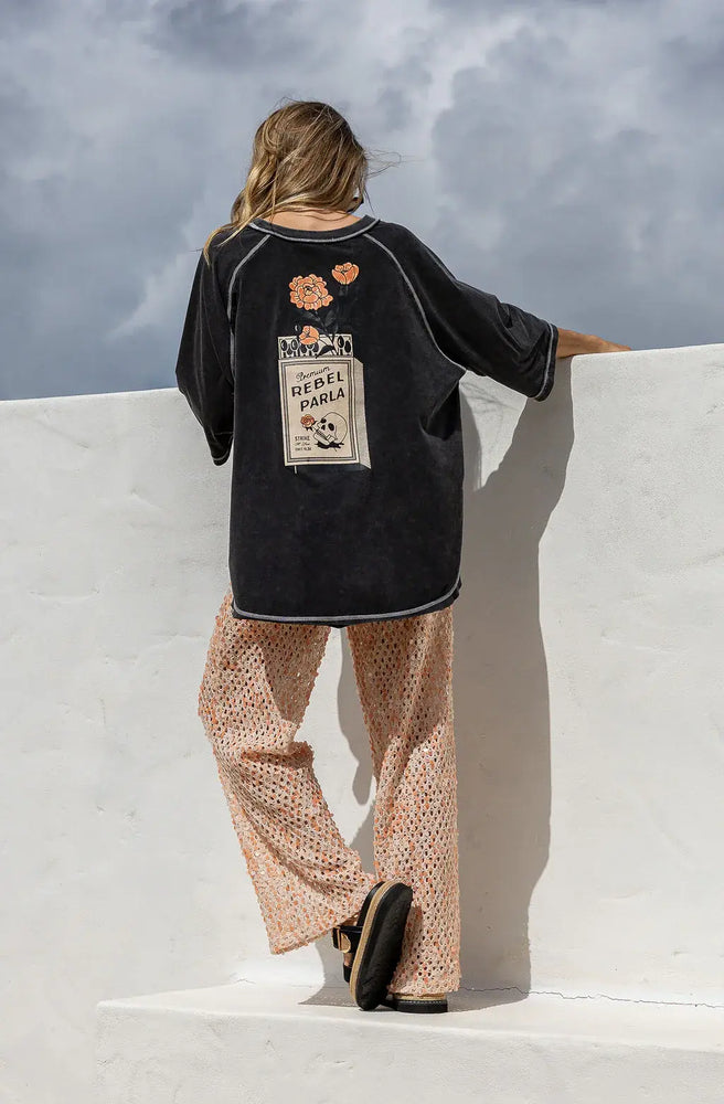 Women's oversized vintage wash graphic t-shirt featuring Rebel Parla artwork and relaxed everyday fit.