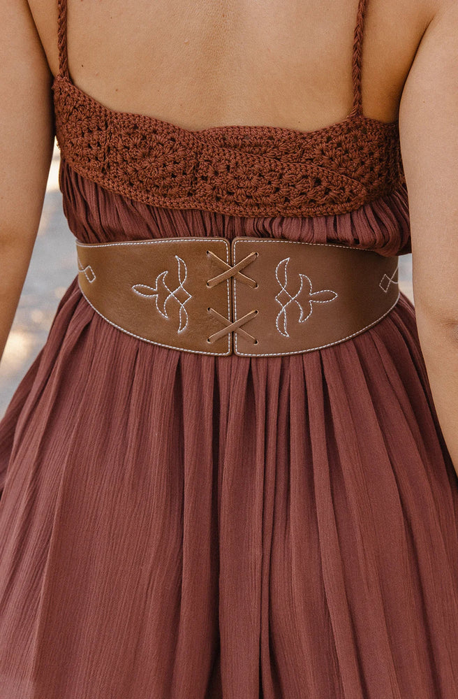 Women's genuine brown leather belt with decorative buckle and adjustable fit.