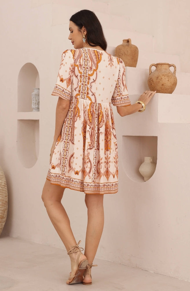 Back view of the Sienna Paisley Mini Dress showing the flowing gathered skirt and intricate paisley pattern.
