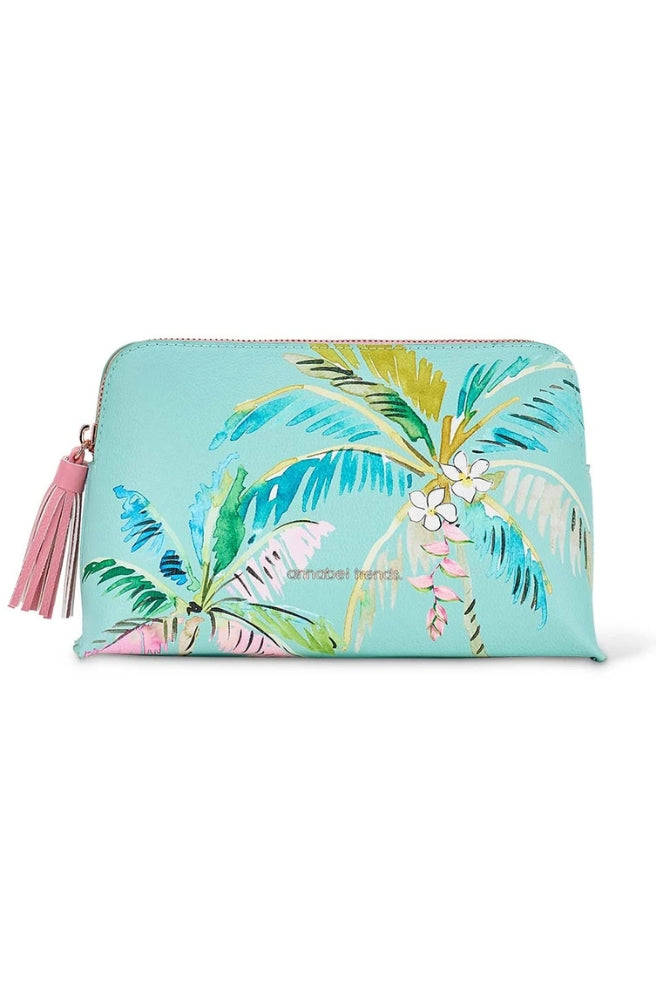 Vanity Bag Tiki Island – Medium featuring a turquoise tropical palm print and pink tassel zipper pull.