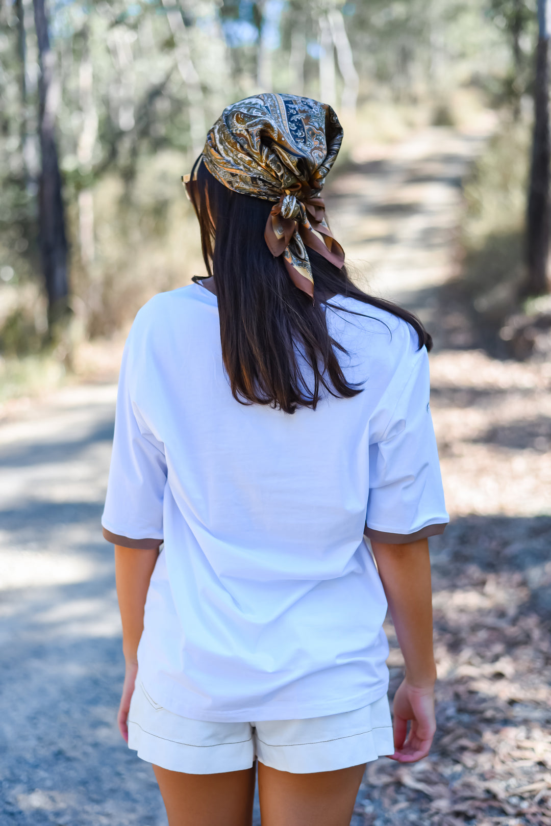 Back view of the White Soul Surf Tee showing its plain white back, relaxed fit and contrasting brown sleeve trim.