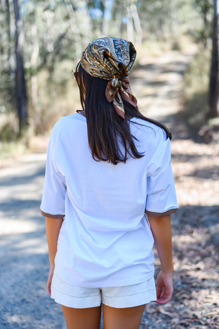 Back view of the White Soul Surf Tee showing its plain white back, relaxed fit and contrasting brown sleeve trim.